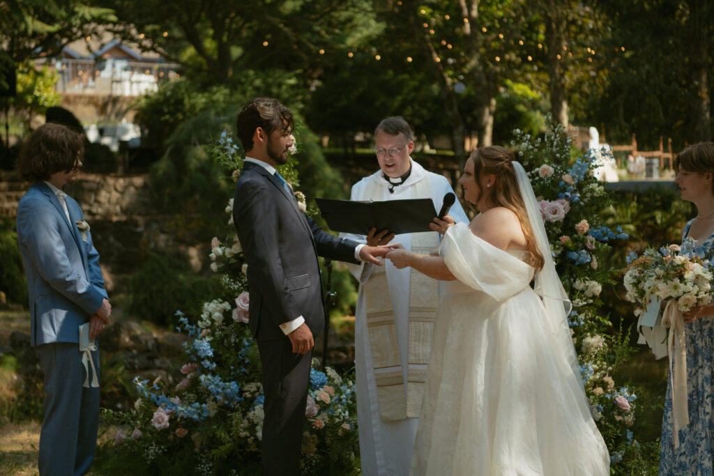 Bride and groom exchanging rings during their wedding ceremony, captured in a close-up moment.