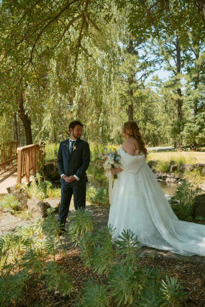 Groom turning to see the bride for the first time in an emotional first look before their wedding ceremony.