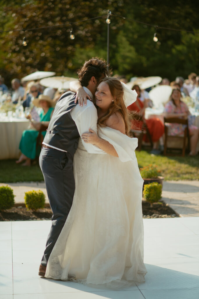 Bride and groom sharing their first dance at the mount tom house, captured in a candid photo by Oregon destination wedding photographer.