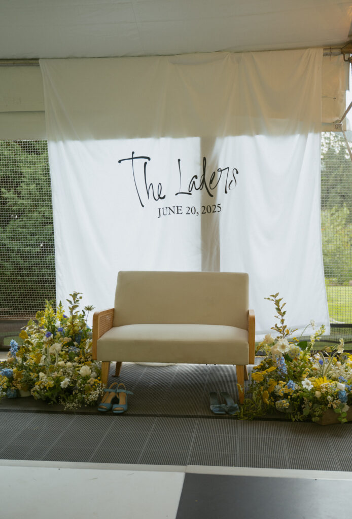 reception details of dance floor and couch with couples last name and flowers