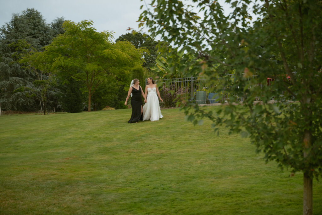 couple walking into the reception to see the guests