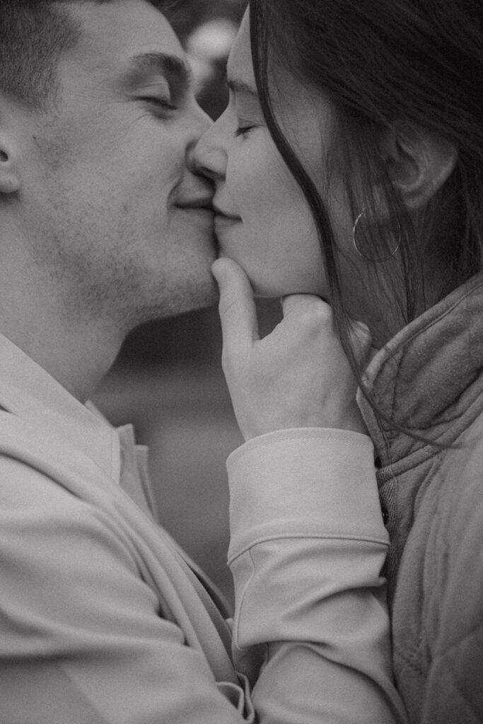 Black and white photo of couple kissing