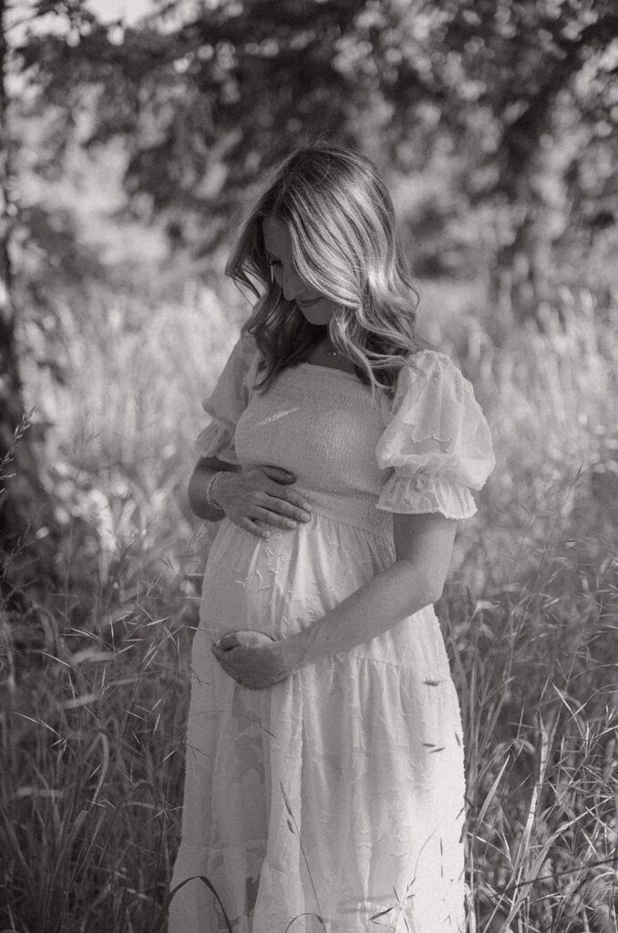 maternity client standing looking at her belly eugene OR