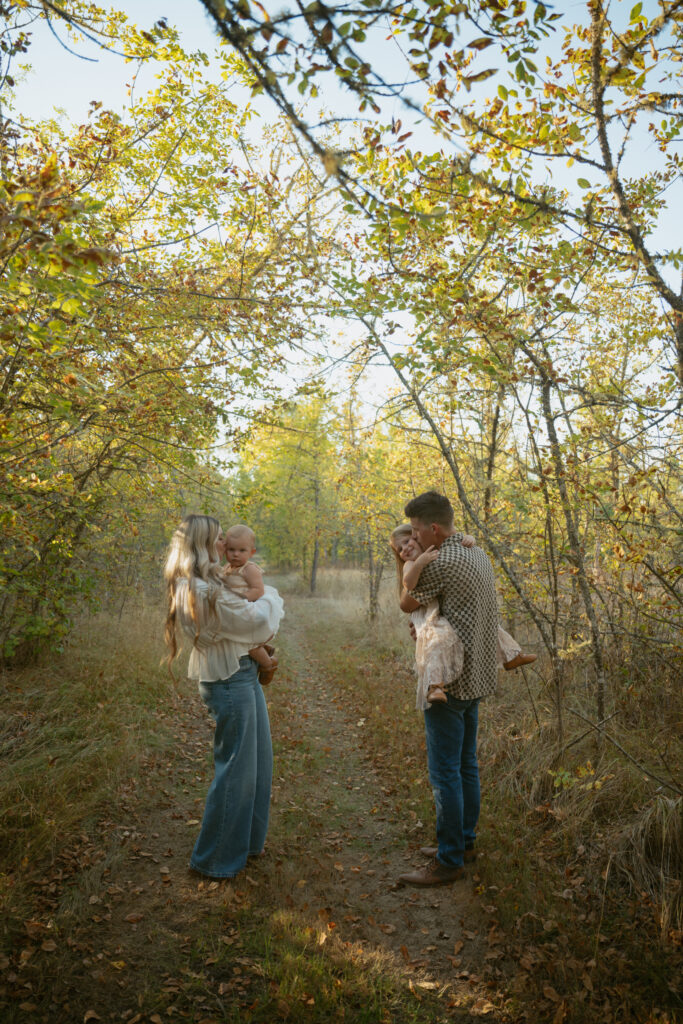 mom and dad holding there kids