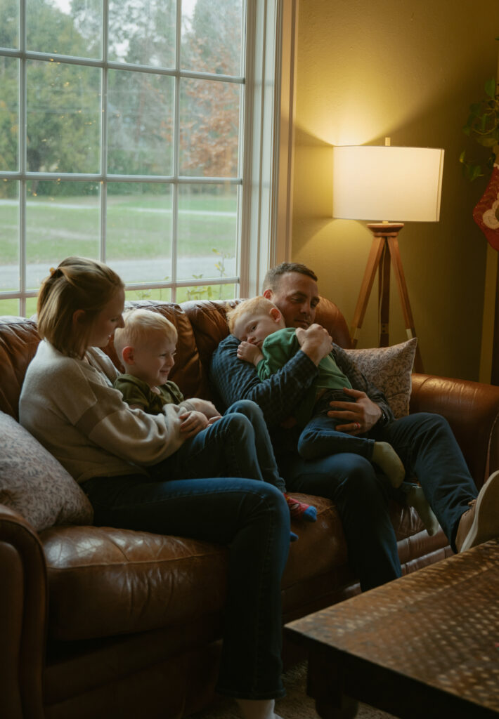 Family cuddling on the couch