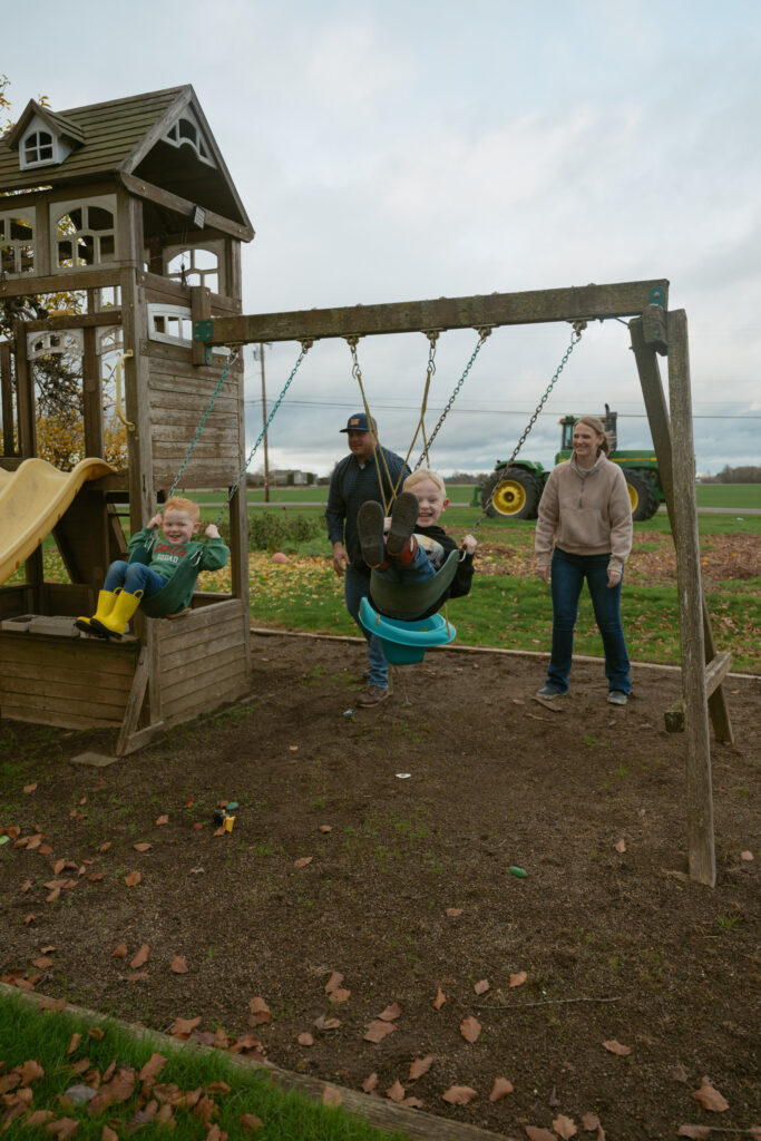 A in home family session with the kids playing on the swings for photos